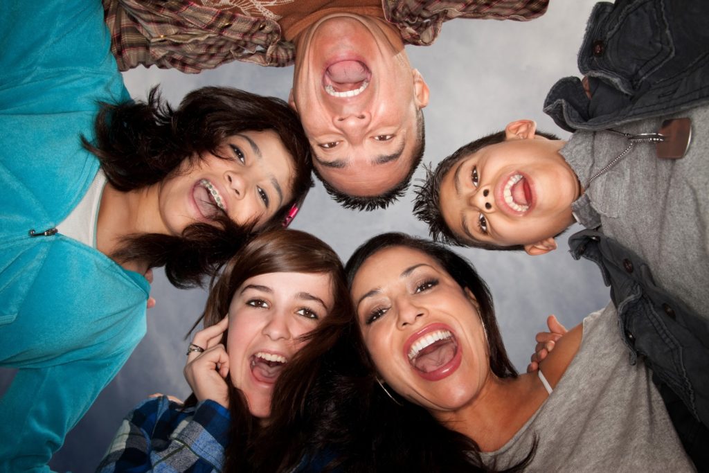 family smiling in a circle