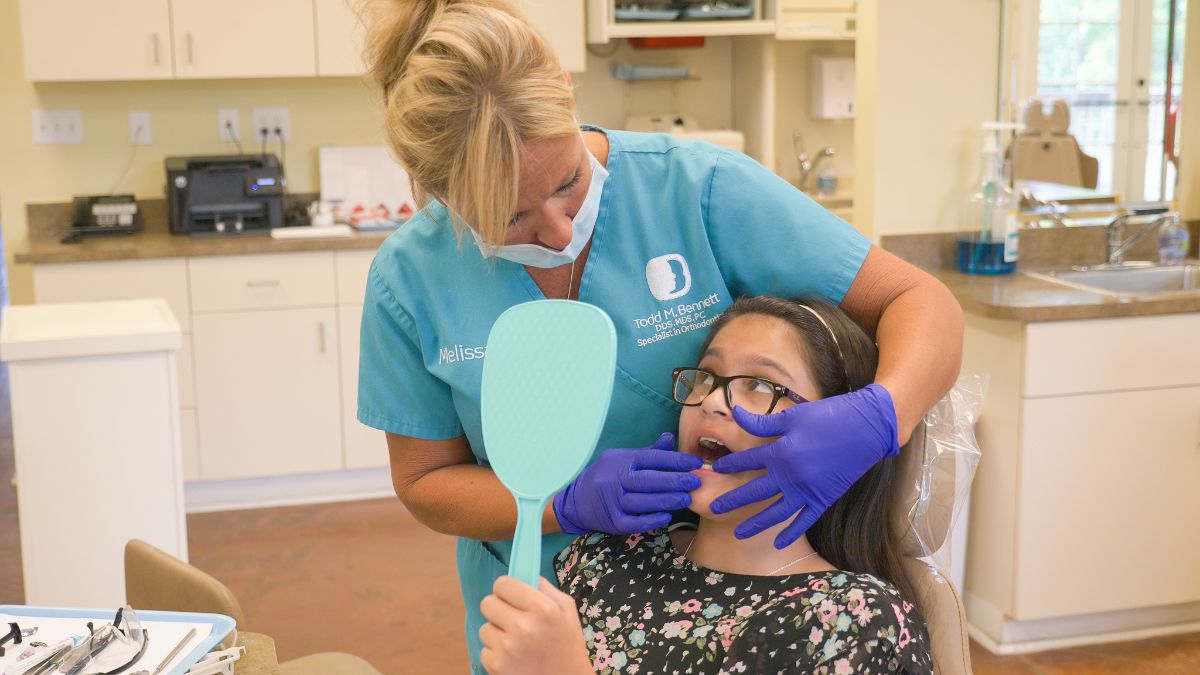 Bennett assistant working on patient's teeth