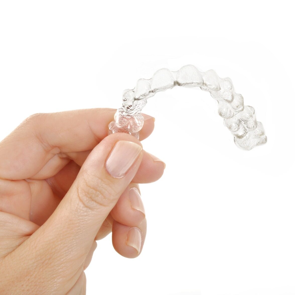 Hand displaying Invisalign aligner hand displaying invisible aligner